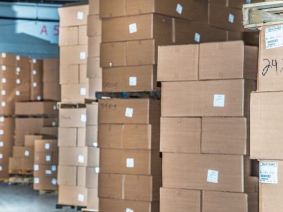 warehouse pallets stacked with packaging cartons showing high inventory levels in distribution center